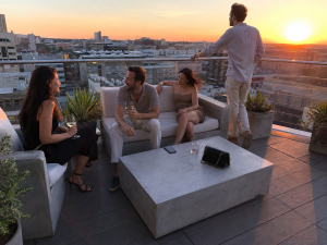 hotel rooftop lounge guests concrete furniture skyline