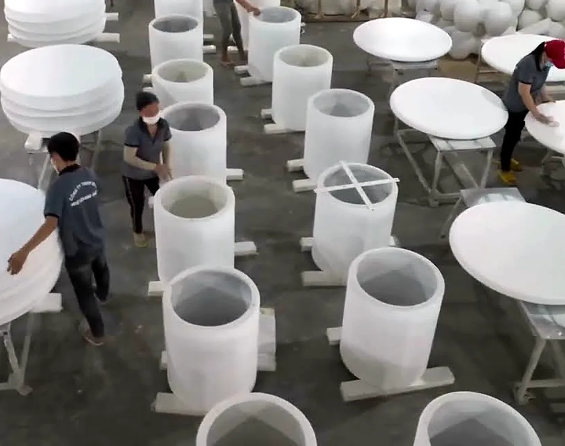 Finishing floor at the Q-Furniture factory in Ho Chi Minh City with white concrete table tops and cylinder bases