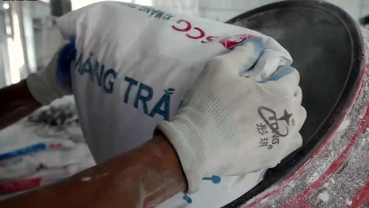 Gloved hands working GFRC into a mould