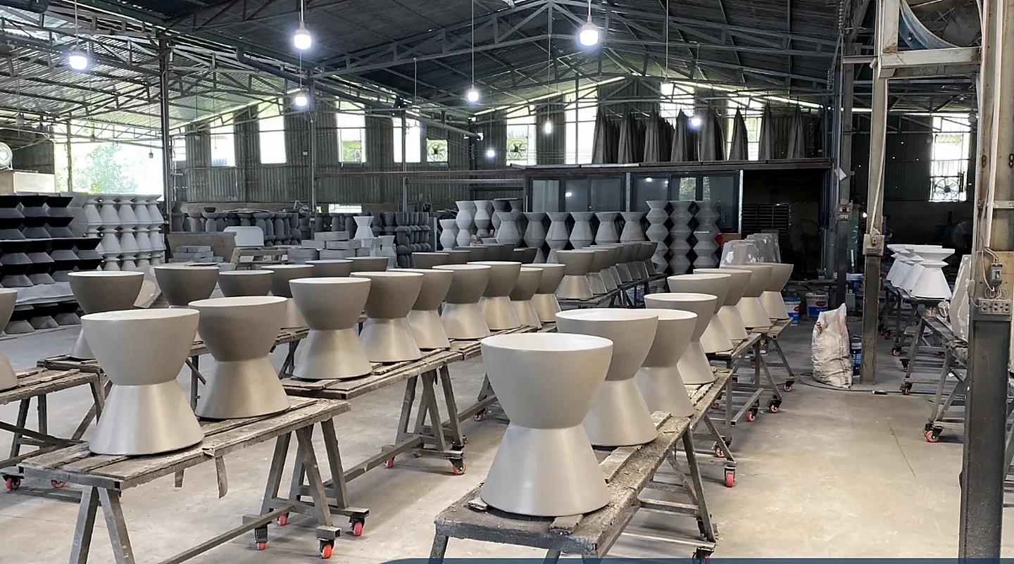 Concrete stools curing on steel racks